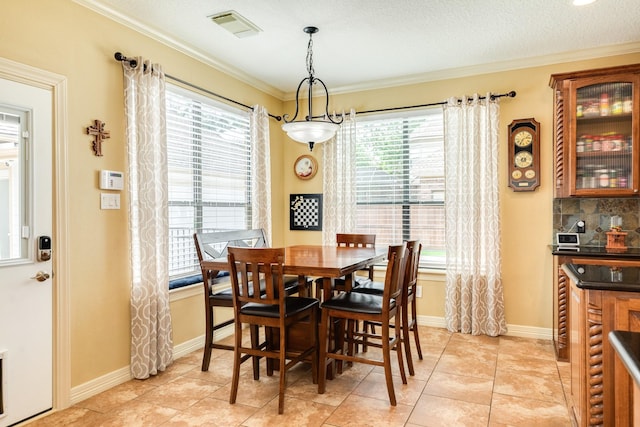 114 Arrowhead Dr, Lake Jackson, TX 77566 - dining space with ornamental molding and light tile patterned floors