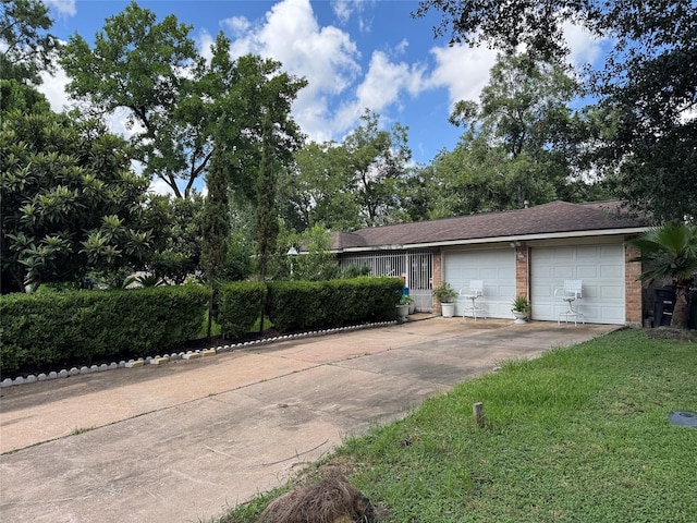 9227 Vanwood St, Houston, TX 77040 - view of front of home featuring brick siding, concrete driveway, an attached garage, and a front lawn
