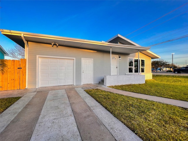 2328 Wimcrest St, Galveston, TX 77551 - view of front of property featuring driveway, an attached garage, and a front lawn
