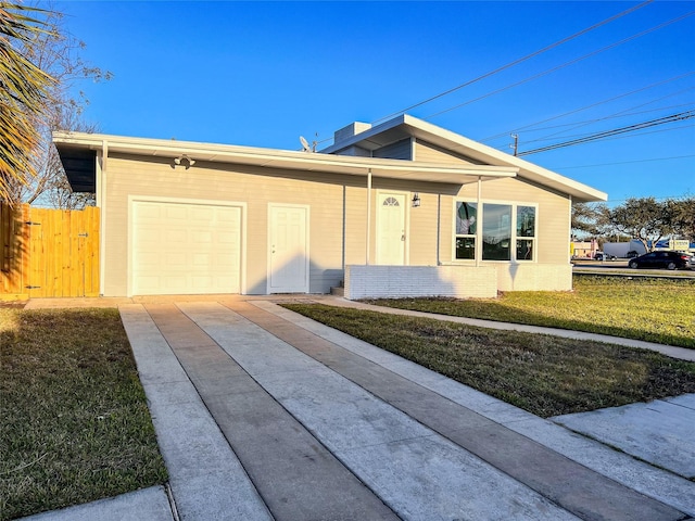 2328 Wimcrest St, Galveston, TX 77551 - view of front facade with concrete driveway and an attached garage