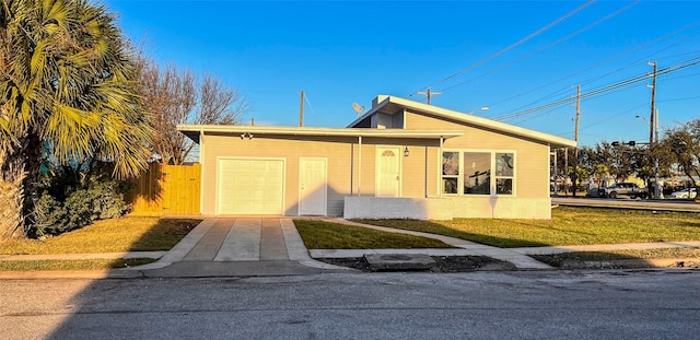 2328 Wimcrest St, Galveston, TX 77551 - view of front of house with a garage, a front lawn, and driveway