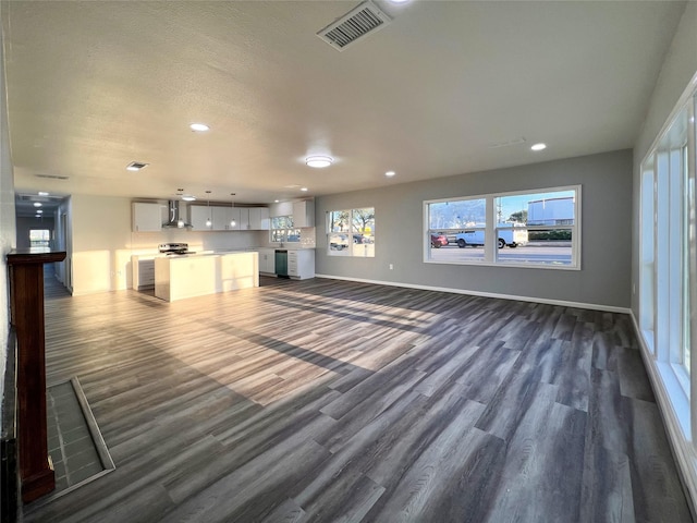 2328 Wimcrest St, Galveston, TX 77551 - unfurnished living room featuring dark wood-type flooring, recessed lighting, and plenty of natural light