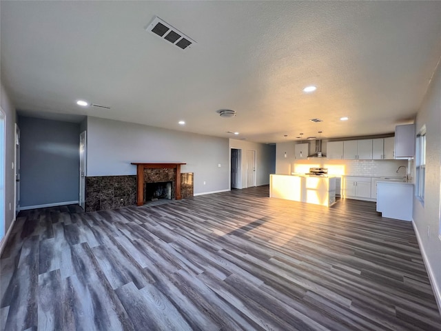2328 Wimcrest St, Galveston, TX 77551 - unfurnished living room featuring recessed lighting, dark wood-style floors, and a fireplace