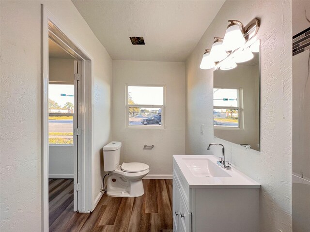 2328 Wimcrest St, Galveston, TX 77551 - bathroom featuring wood finished floors, vanity, and a textured wall