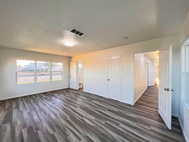 2328 Wimcrest St, Galveston, TX 77551 - unfurnished living room featuring dark wood-type flooring and baseboards