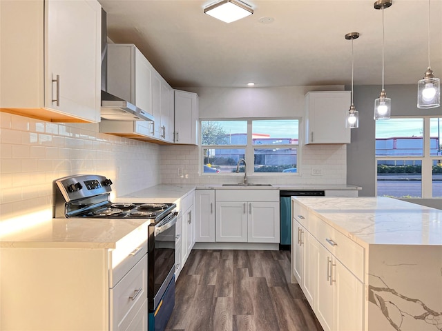 2328 Wimcrest St, Galveston, TX 77551 - kitchen with stainless steel appliances, dark wood-style flooring, light stone counters, and healthy amount of natural light