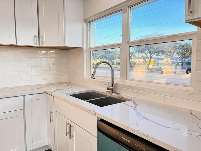 2328 Wimcrest St, Galveston, TX 77551 - kitchen featuring dishwashing machine, white cabinetry, backsplash, and healthy amount of natural light