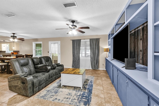 202 Twin Harbors Dr, Onalaska, TX 77360 - living area featuring ceiling fan, a textured ceiling, and light tile patterned floors