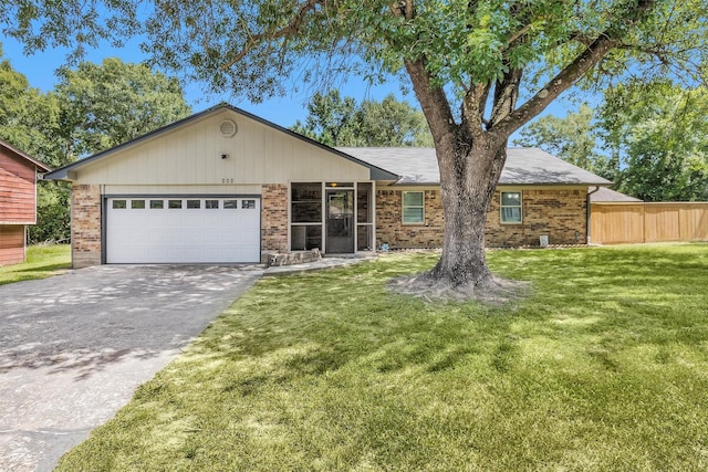 202 Twin Harbors Dr, Onalaska, TX 77360 - ranch-style home featuring concrete driveway, brick siding, and a garage
