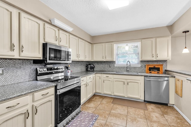 202 Twin Harbors Dr, Onalaska, TX 77360 - kitchen featuring stainless steel appliances, tasteful backsplash, a textured ceiling, decorative light fixtures, and light stone counters