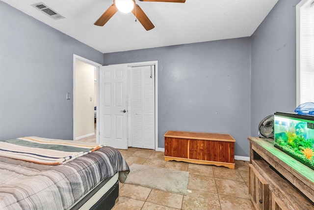 202 Twin Harbors Dr, Onalaska, TX 77360 - bedroom featuring a closet, ceiling fan, and light tile patterned floors