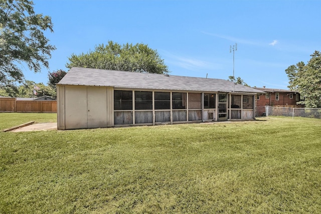 202 Twin Harbors Dr, Onalaska, TX 77360 - rear view of house featuring a fenced backyard and a sunroom