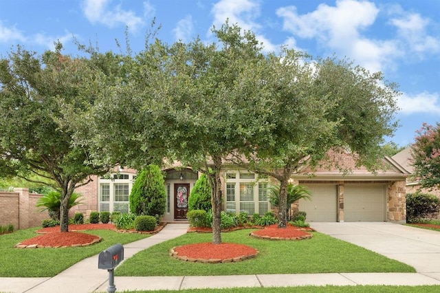 13603 Sand Mountain Ln, Houston, TX 77044 - obstructed view of property with a garage, concrete driveway, and stone siding
