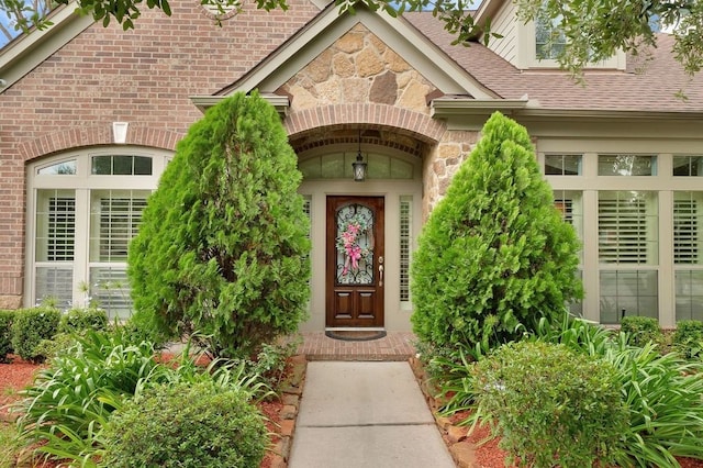 13603 Sand Mountain Ln, Houston, TX 77044 - entrance to property with stone siding, a shingled roof, and brick siding