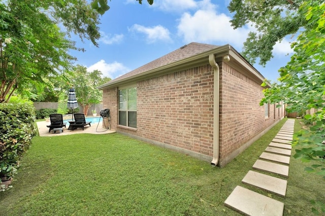 13603 Sand Mountain Ln, Houston, TX 77044 - view of property exterior with brick siding, a patio, and roof with shingles