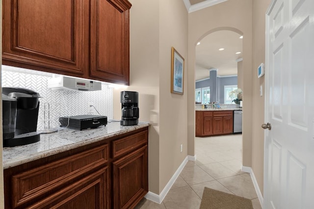 13603 Sand Mountain Ln, Houston, TX 77044 - kitchen featuring crown molding, arched walkways, decorative backsplash, dishwasher, and light stone counters