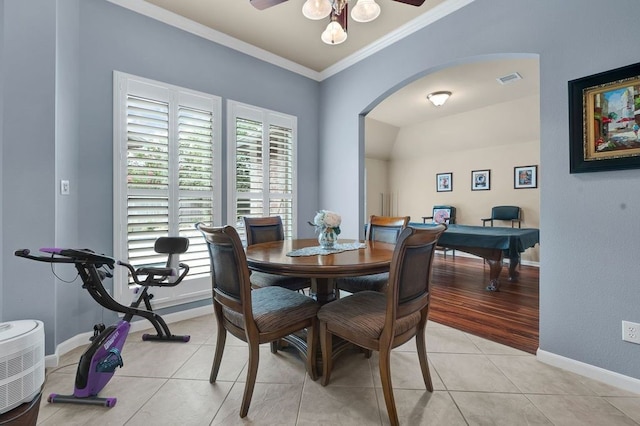 13603 Sand Mountain Ln, Houston, TX 77044 - dining area featuring crown molding, arched walkways, a ceiling fan, and light tile patterned floors