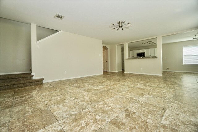 2434 Ranch Hollow Ct, Katy, TX 77494 - unfurnished living room with stairs and arched walkways