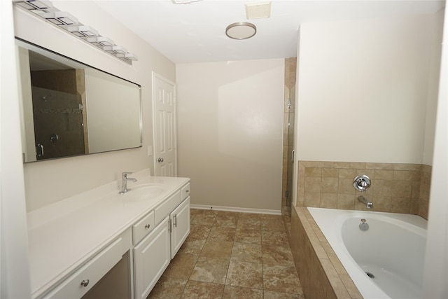 2434 Ranch Hollow Ct, Katy, TX 77494 - bathroom with vanity, a garden tub, an enclosed shower, and stone finish floors