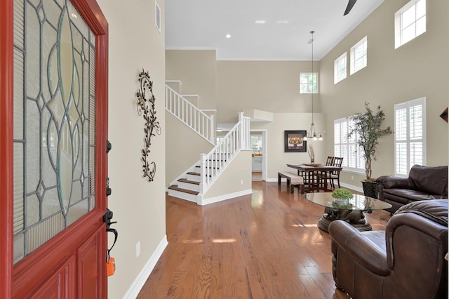 46 Lightwood Trce, The Woodlands, TX 77382 - entrance foyer with wood finished floors, stairs, a high ceiling, crown molding, and recessed lighting