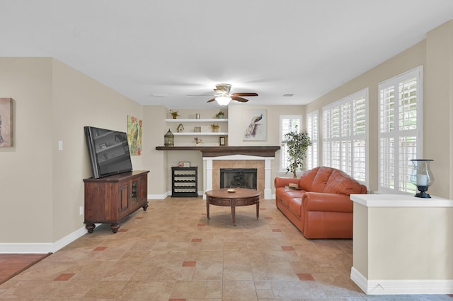 46 Lightwood Trce, The Woodlands, TX 77382 - living room featuring healthy amount of natural light, a ceiling fan, a fireplace, and stone finish flooring