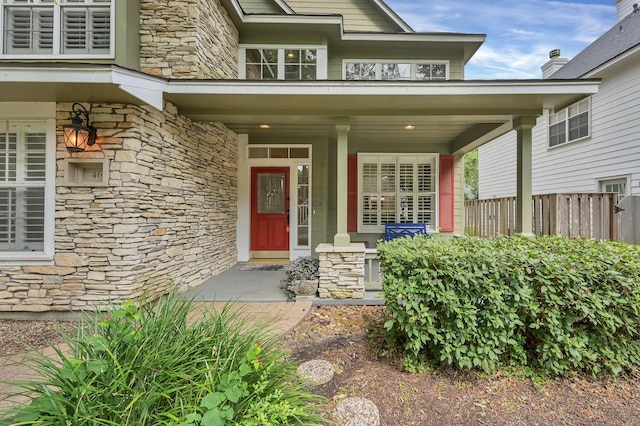 46 Lightwood Trce, The Woodlands, TX 77382 - view of exterior entry featuring stone siding and covered porch
