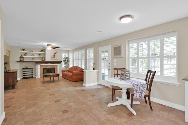 46 Lightwood Trce, The Woodlands, TX 77382 - dining room with a ceiling fan and a tiled fireplace