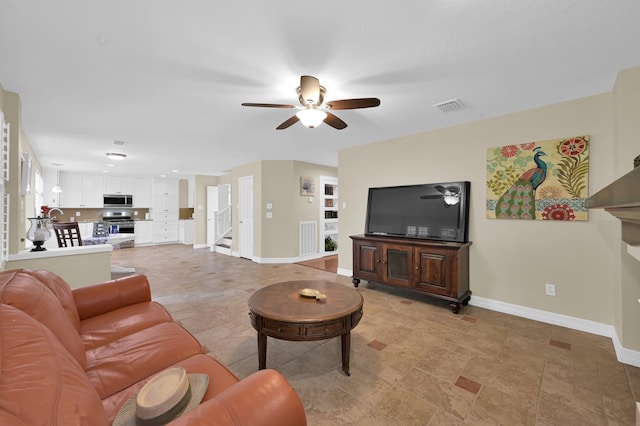 46 Lightwood Trce, The Woodlands, TX 77382 - living room featuring a ceiling fan, stairs, and a fireplace