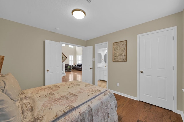 46 Lightwood Trce, The Woodlands, TX 77382 - bedroom with wood finished floors and connected bathroom