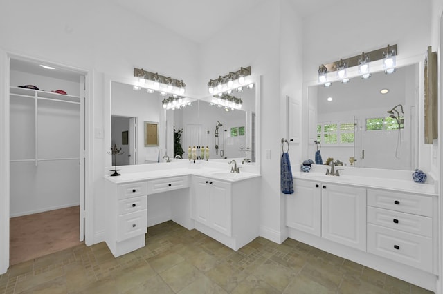 46 Lightwood Trce, The Woodlands, TX 77382 - bathroom with stone finish floors, two vanities, and a spacious closet
