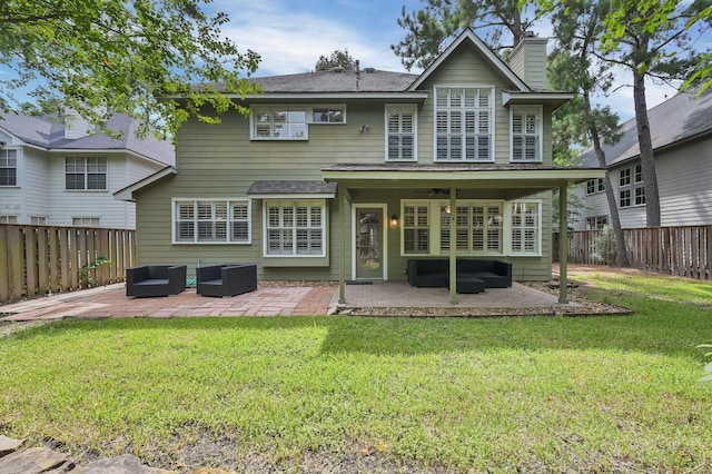 46 Lightwood Trce, The Woodlands, TX 77382 - back of house featuring outdoor lounge area, a patio, and a fenced backyard