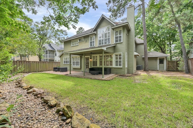 46 Lightwood Trce, The Woodlands, TX 77382 - back of house with a patio, a fenced backyard, a chimney, ceiling fan, and a gate
