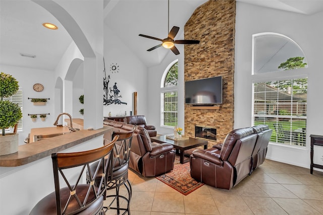 7710 Aerobic Ave, Humble, TX 77346 - living area with high vaulted ceiling, healthy amount of natural light, ceiling fan, and a stone fireplace