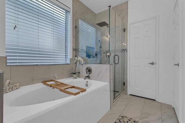 7710 Aerobic Ave, Humble, TX 77346 - bathroom featuring a bath, a stall shower, and marble finish floors