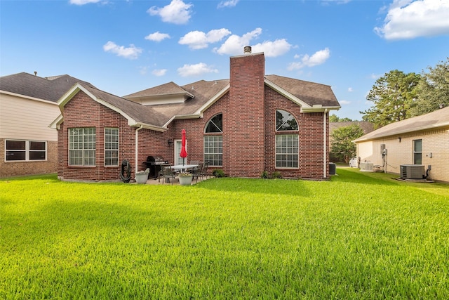7710 Aerobic Ave, Humble, TX 77346 - back of property featuring a chimney, brick siding, a lawn, and a patio
