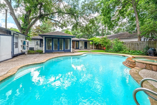 1226 Timbergrove Ln, Houston, TX 77008 - view of pool featuring a pool with connected hot tub, french doors, and a patio area