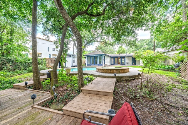 1226 Timbergrove Ln, Houston, TX 77008 - rear view of property featuring a wooden deck, a fenced backyard, a pool with connected hot tub, and a storage unit