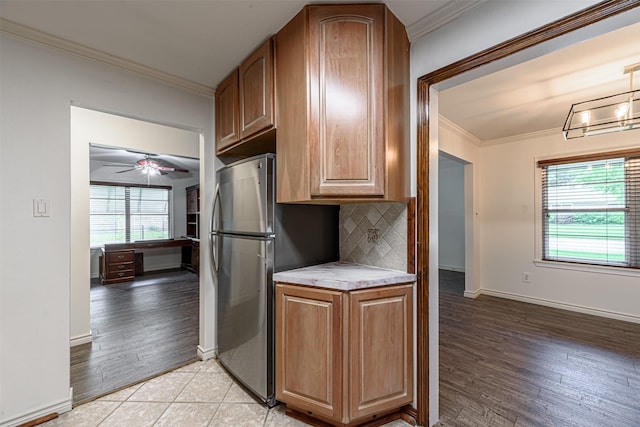 1226 Timbergrove Ln, Houston, TX 77008 - kitchen with ornamental molding, light countertops, freestanding refrigerator, decorative backsplash, and light wood-type flooring