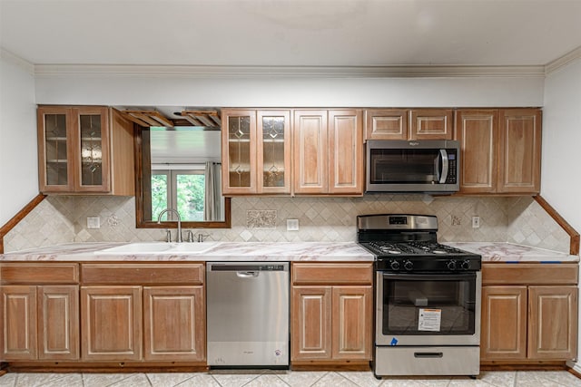 1226 Timbergrove Ln, Houston, TX 77008 - kitchen with stainless steel appliances, light countertops, crown molding, and backsplash