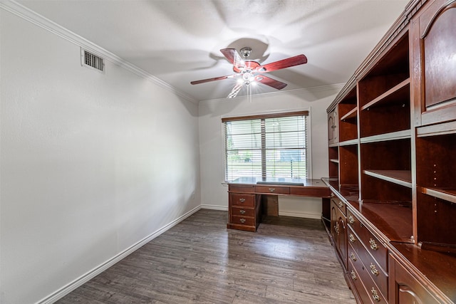 1226 Timbergrove Ln, Houston, TX 77008 - unfurnished office featuring ceiling fan, crown molding, dark wood finished floors, and built in desk