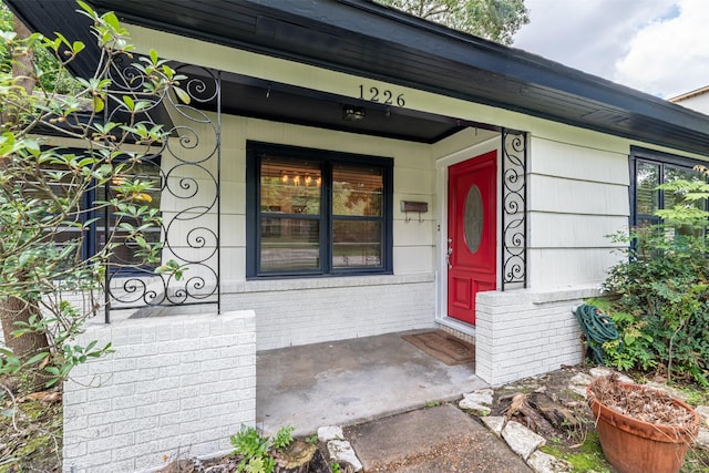 1226 Timbergrove Ln, Houston, TX 77008 - view of exterior entry with brick siding and a porch