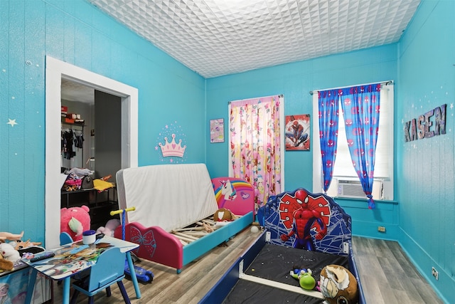 208 S Cloud St, Wharton, TX 77488 - bedroom with wood finished floors and cooling unit