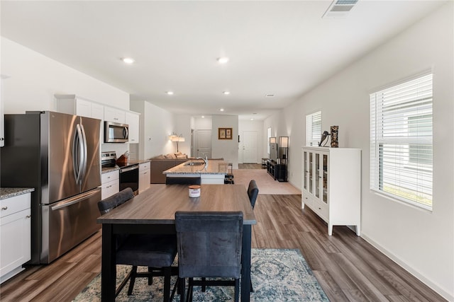 10138 California Lily Ln, Houston, TX 77016 - dining room with dark wood-style floors and recessed lighting