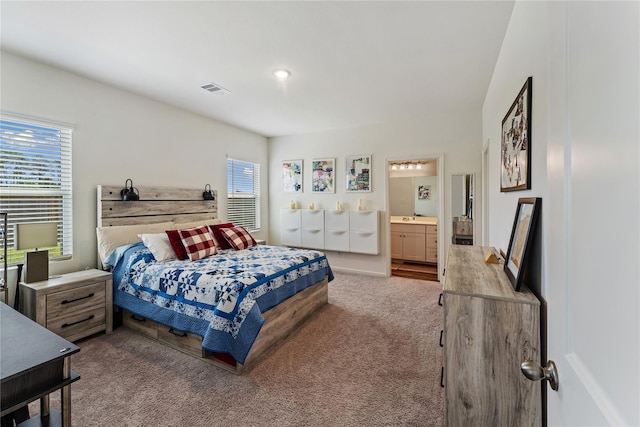 10138 California Lily Ln, Houston, TX 77016 - carpeted bedroom with multiple windows and ensuite bath