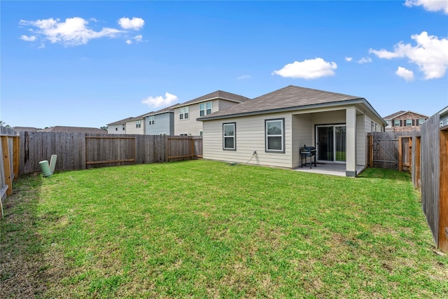 10138 California Lily Ln, Houston, TX 77016 - rear view of house with a fenced backyard and a patio area
