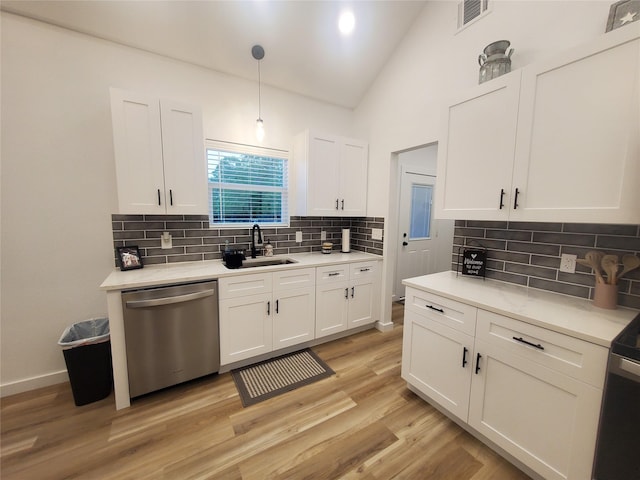 95 Red Tip Ln, Brenham, TX 77833 - kitchen with dishwasher, white cabinets, decorative backsplash, light wood-style flooring, and light countertops