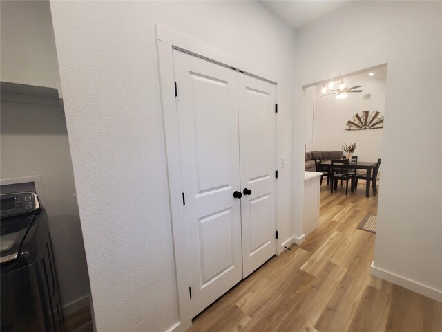 95 Red Tip Ln, Brenham, TX 77833 - hall featuring washer / dryer and light wood finished floors