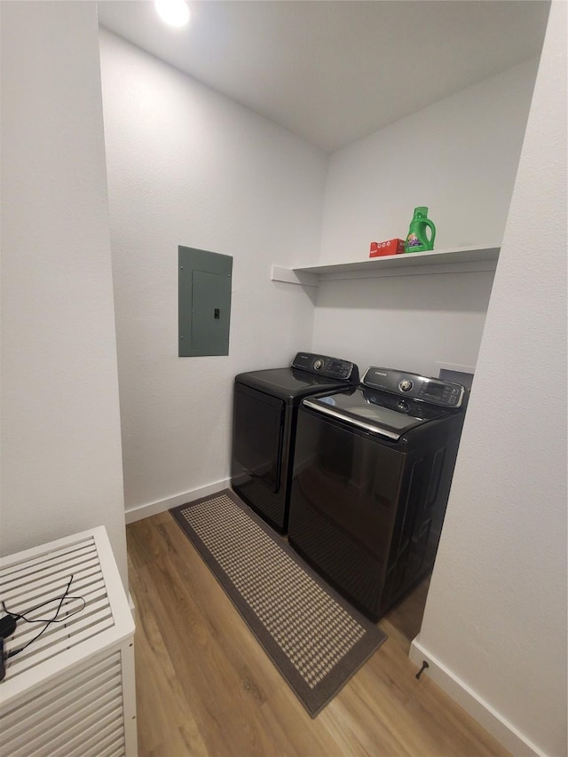 95 Red Tip Ln, Brenham, TX 77833 - laundry area with electric panel, independent washer and dryer, and light wood-style floors