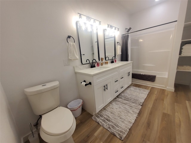 95 Red Tip Ln, Brenham, TX 77833 - bathroom featuring wood finished floors, double vanity, and shower / bath combination with curtain