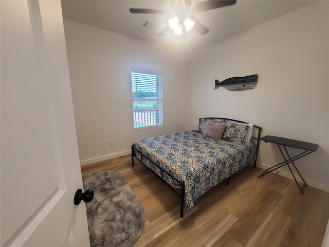 95 Red Tip Ln, Brenham, TX 77833 - bedroom with wood finished floors and a ceiling fan